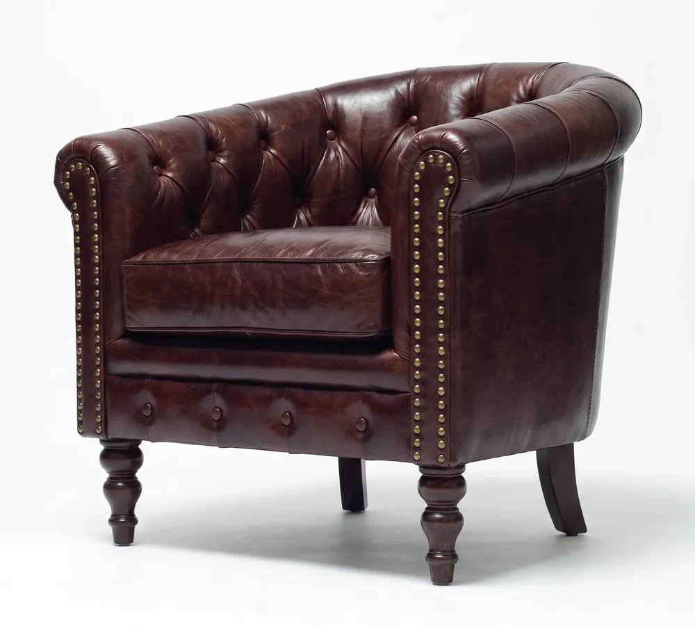 Dark-brown buttoned leather tub club chair after recolour and conditioning